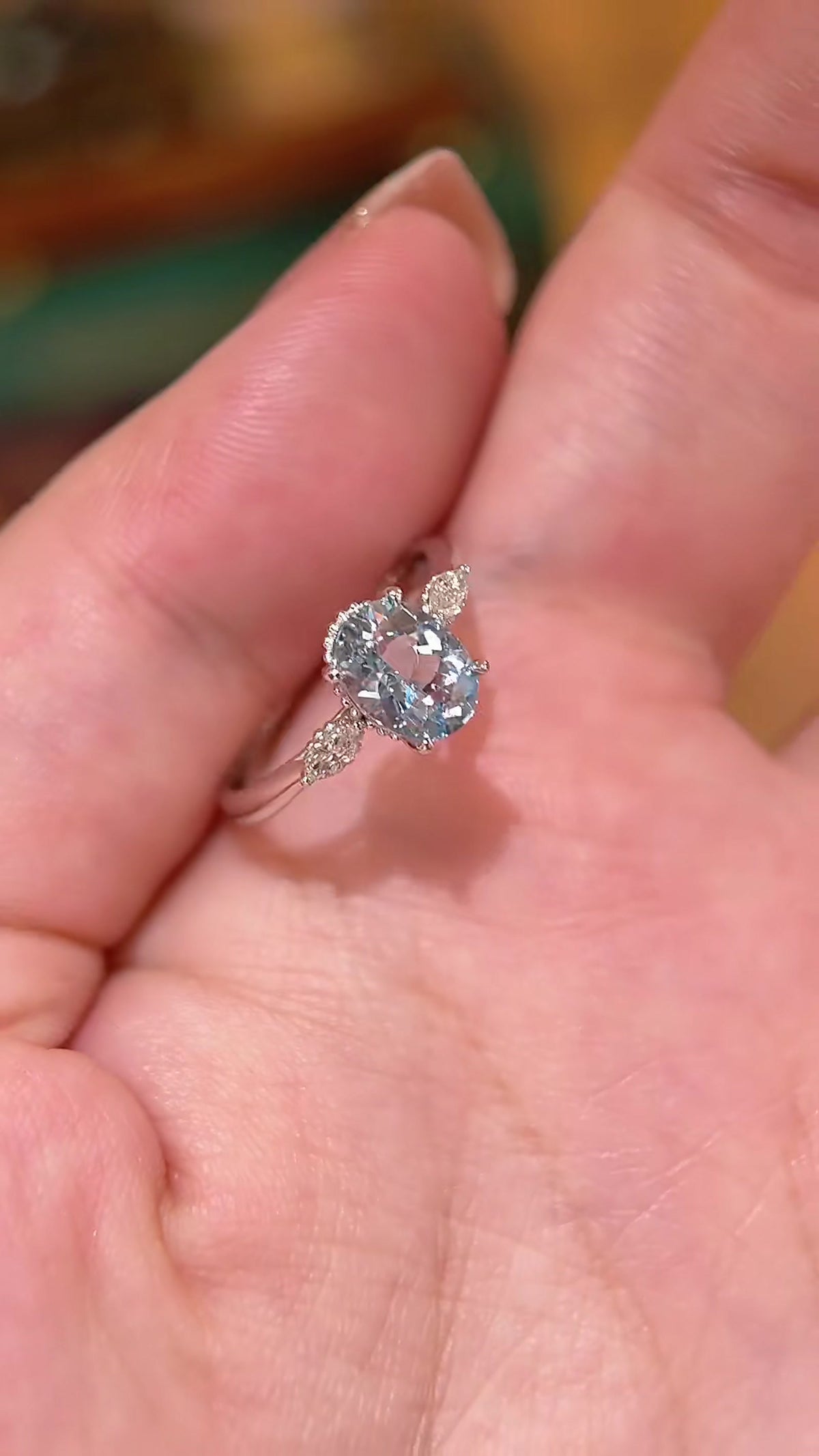 Close-up of lab-grown aquamarine oval engagement ring for spring proposals