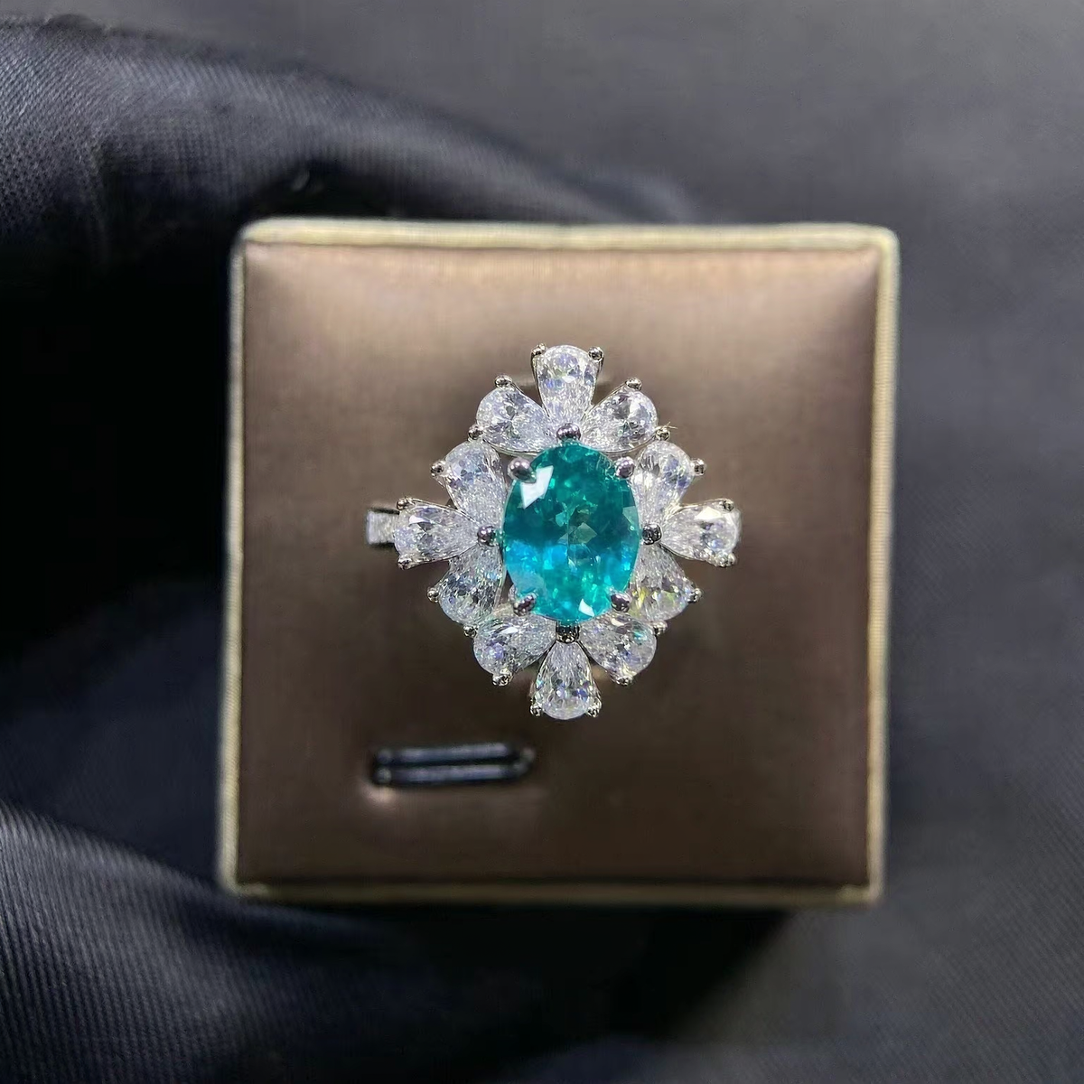 Front view of oval lab-grown Paraiba gemstone floral cluster ring for romantic proposals