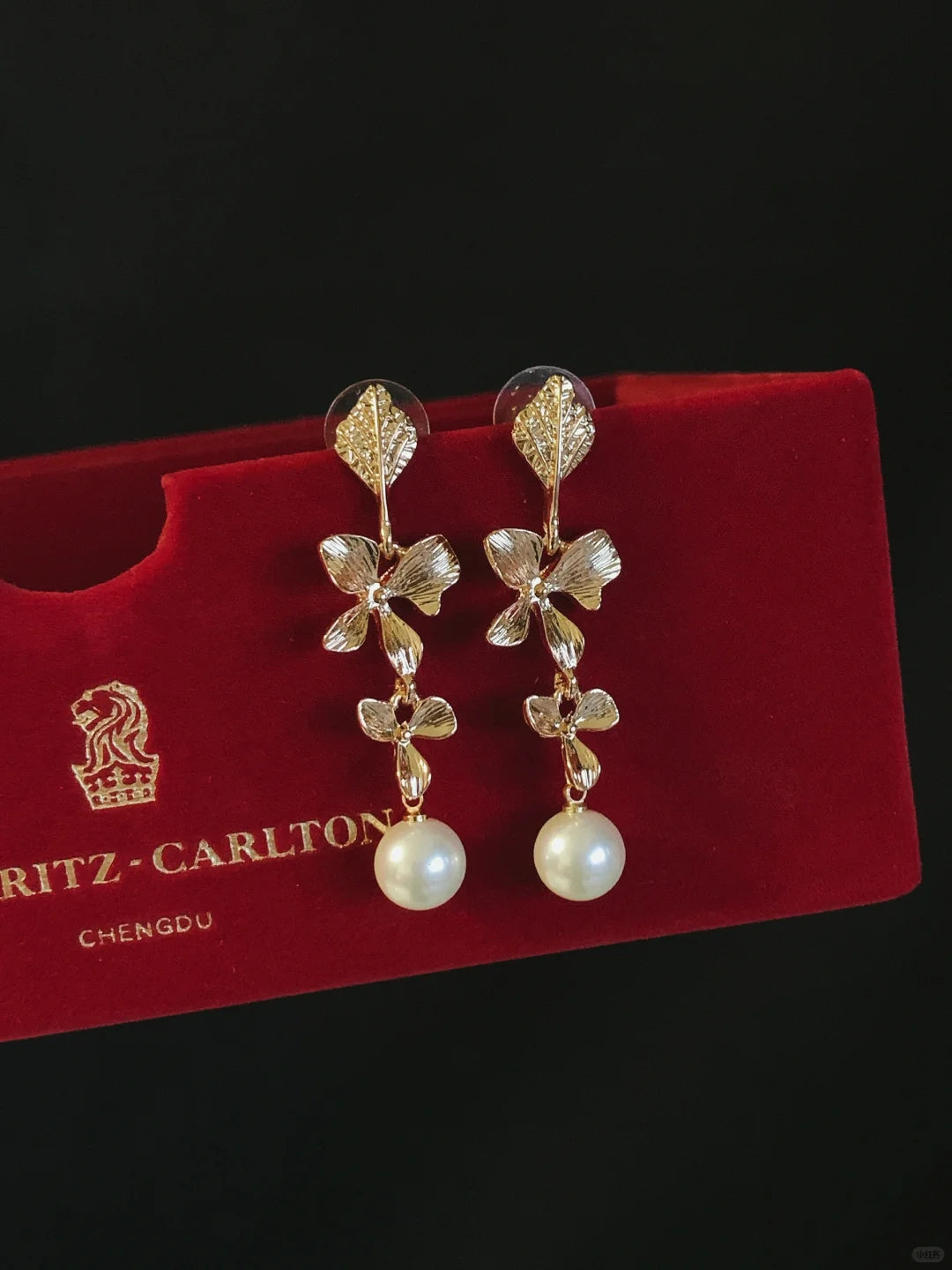 Detail view of orb drop high-lustre freshwater pearl earrings for wedding guest looks
