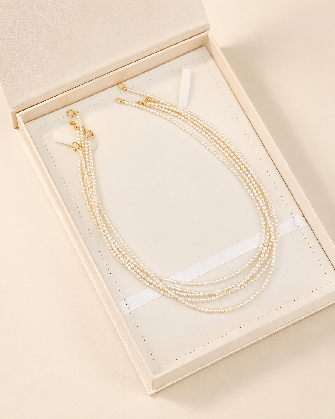 Three-strand freshwater pearl necklace presented in a jewellery box