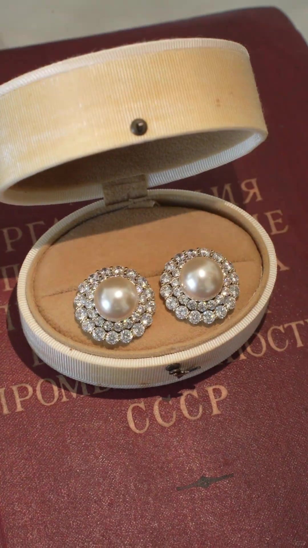 Styled view of halo stud high-lustre freshwater pearl earrings for wedding guest looks