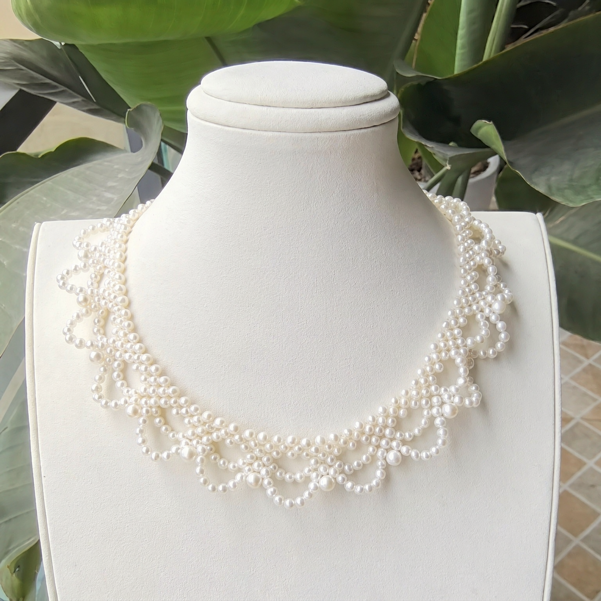 Front view of Opaline Pearl Loop Statement Necklace, a natural freshwater pearl necklace for fashion events