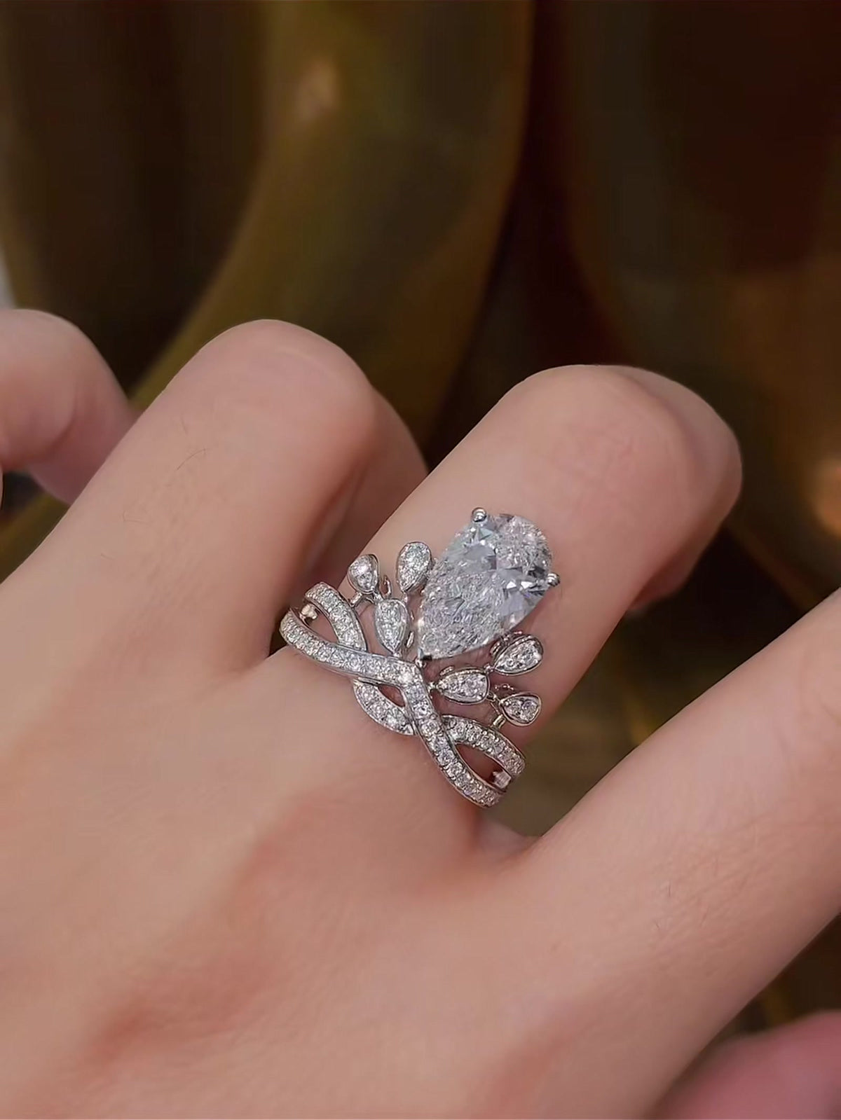 Close-up of lab-grown diamond pear crown engagement ring for fairytale proposals