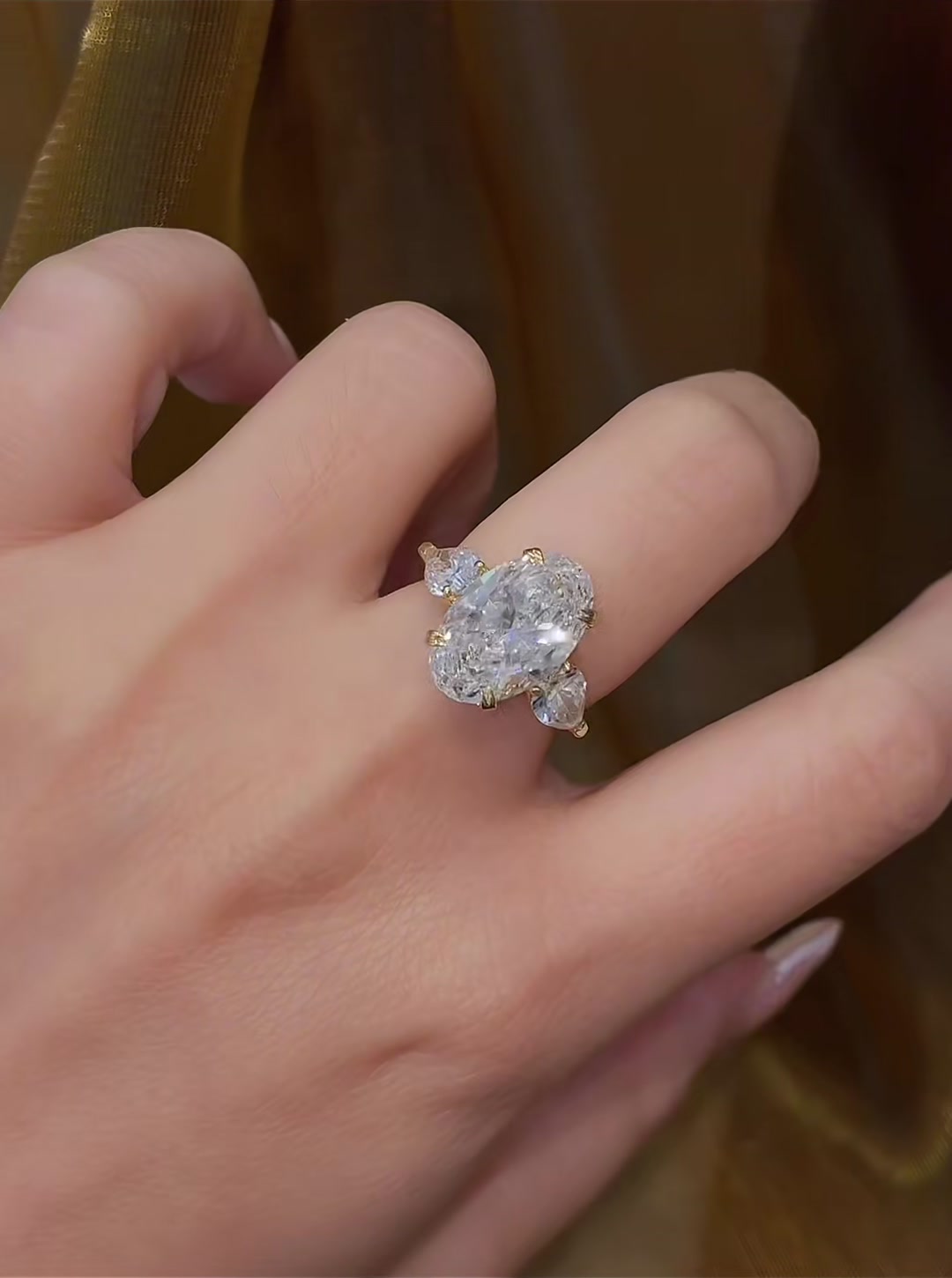 Close-up of lab-grown diamond oval three stone engagement ring for engagement proposals