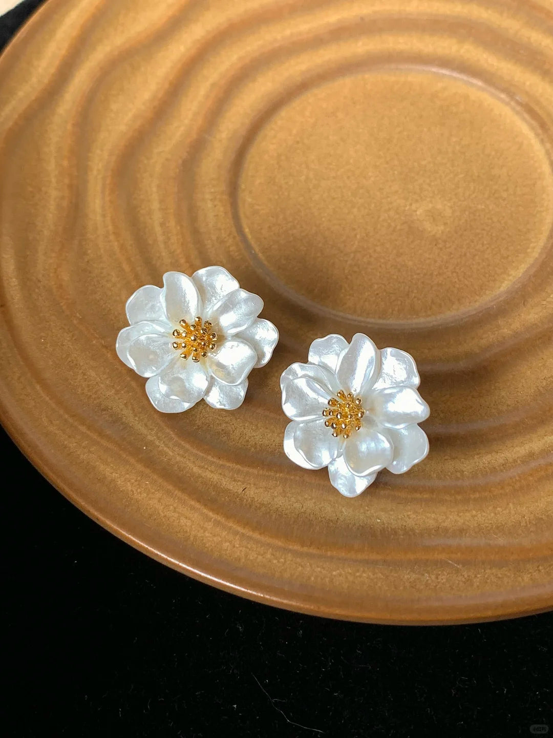 Styled view of white flower stud high-lustre freshwater pearl earrings for wedding guest looks