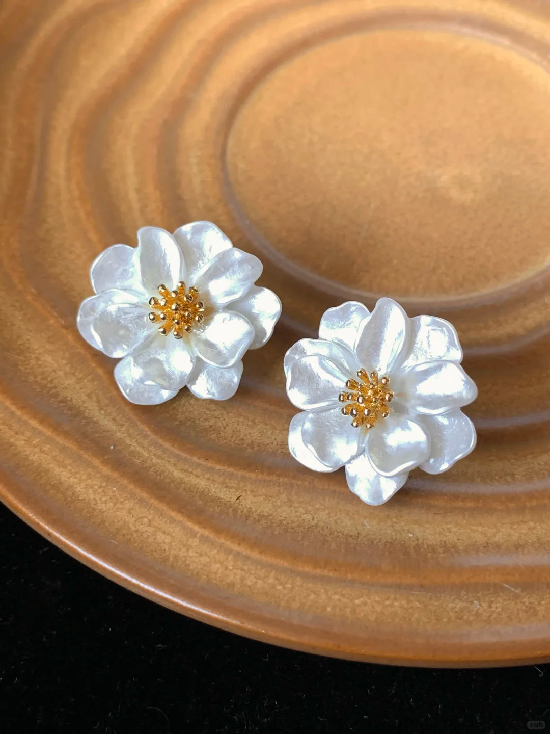 Close-up of white flower stud high-lustre freshwater pearl earrings for wedding guest looks