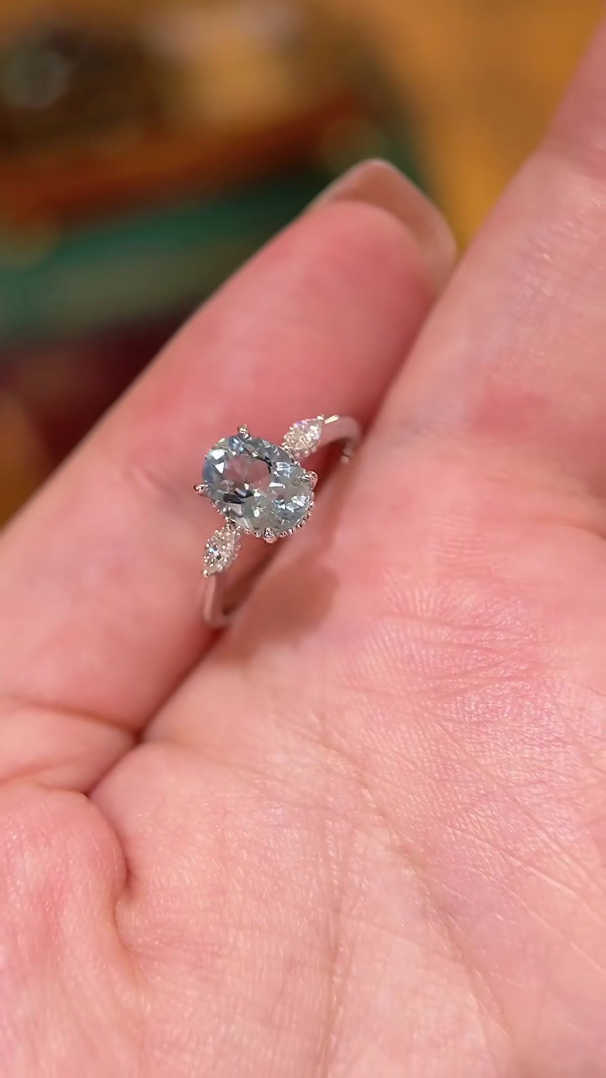 Front view of lab-grown aquamarine oval engagement ring for spring proposals