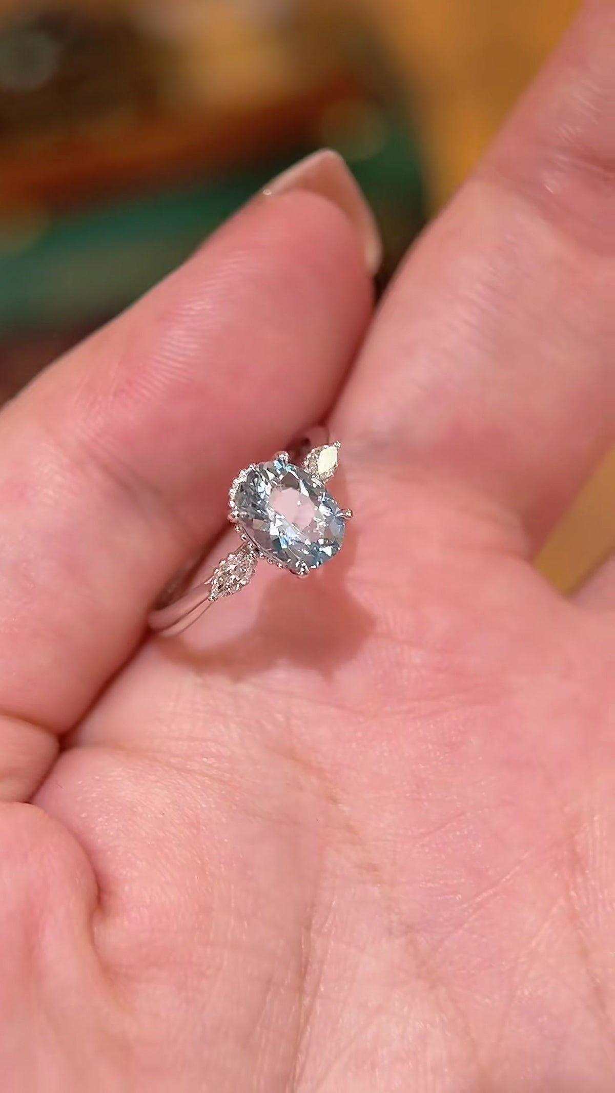Styled view of lab-grown aquamarine oval engagement ring for spring proposals