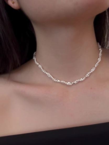 Styled view of layered silver-tone high-lustre freshwater pearl necklace for weddings
