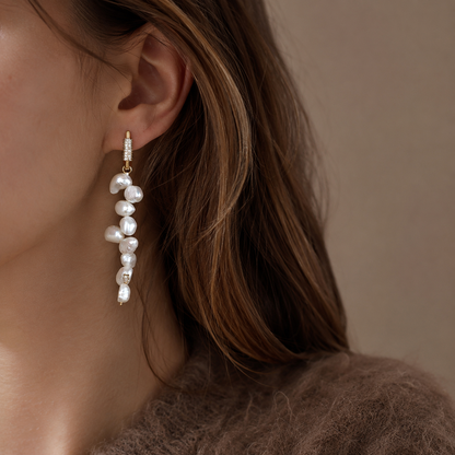 Side view of 14K gold huggie hoop and baroque freshwater pearl drop earring