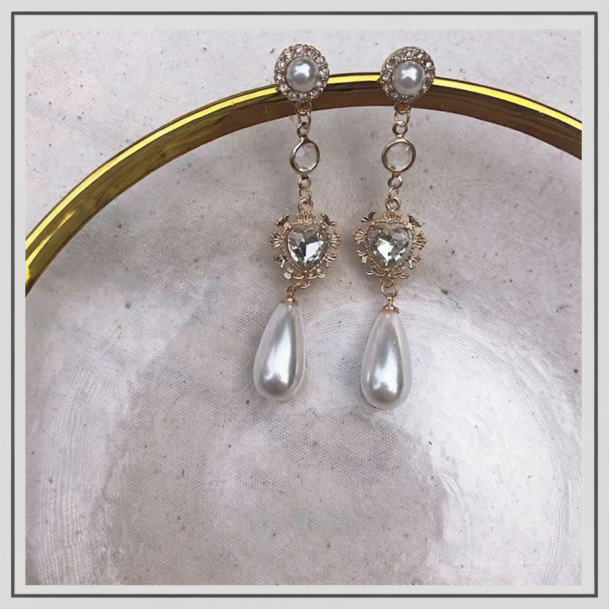 Close-up of long drop high-lustre freshwater pearl earrings for wedding guest looks