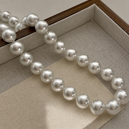 Aurora 12mm Akoya pearl necklace displayed in a jewellery tray