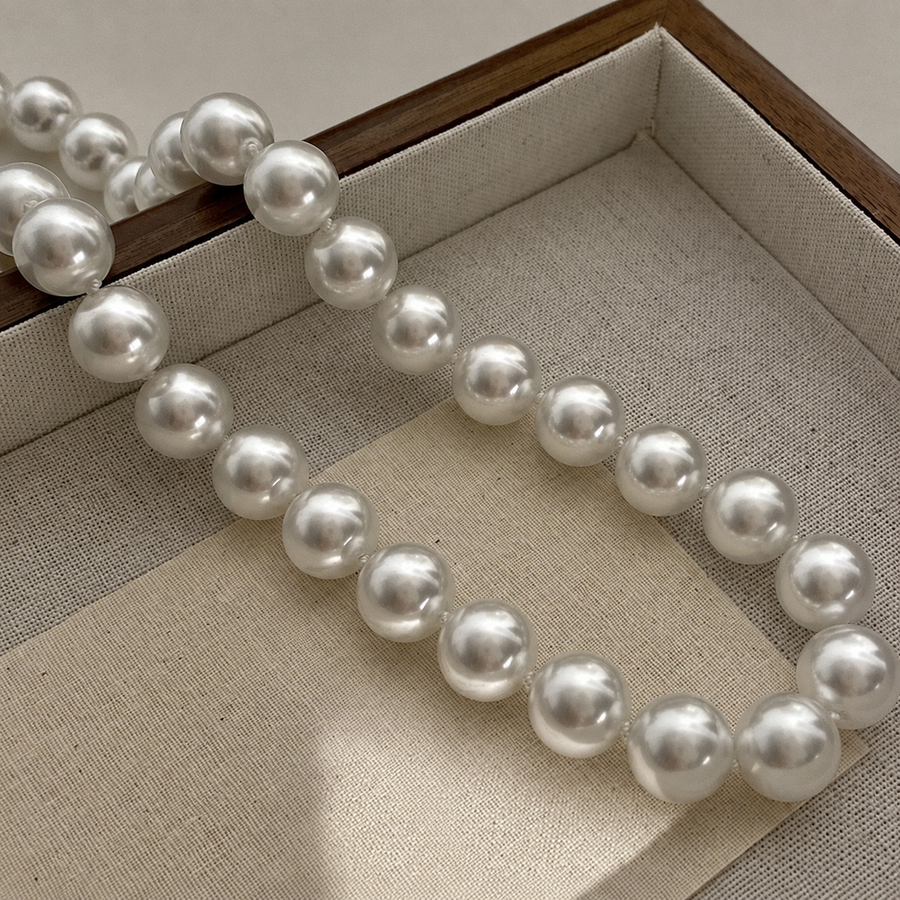 Aurora 12mm Akoya pearl necklace displayed in a jewellery tray