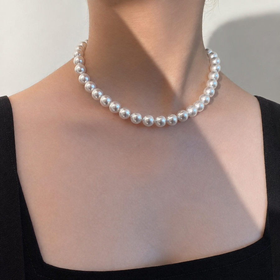 Model wearing a 12mm Akoya pearl necklace at the collarbone