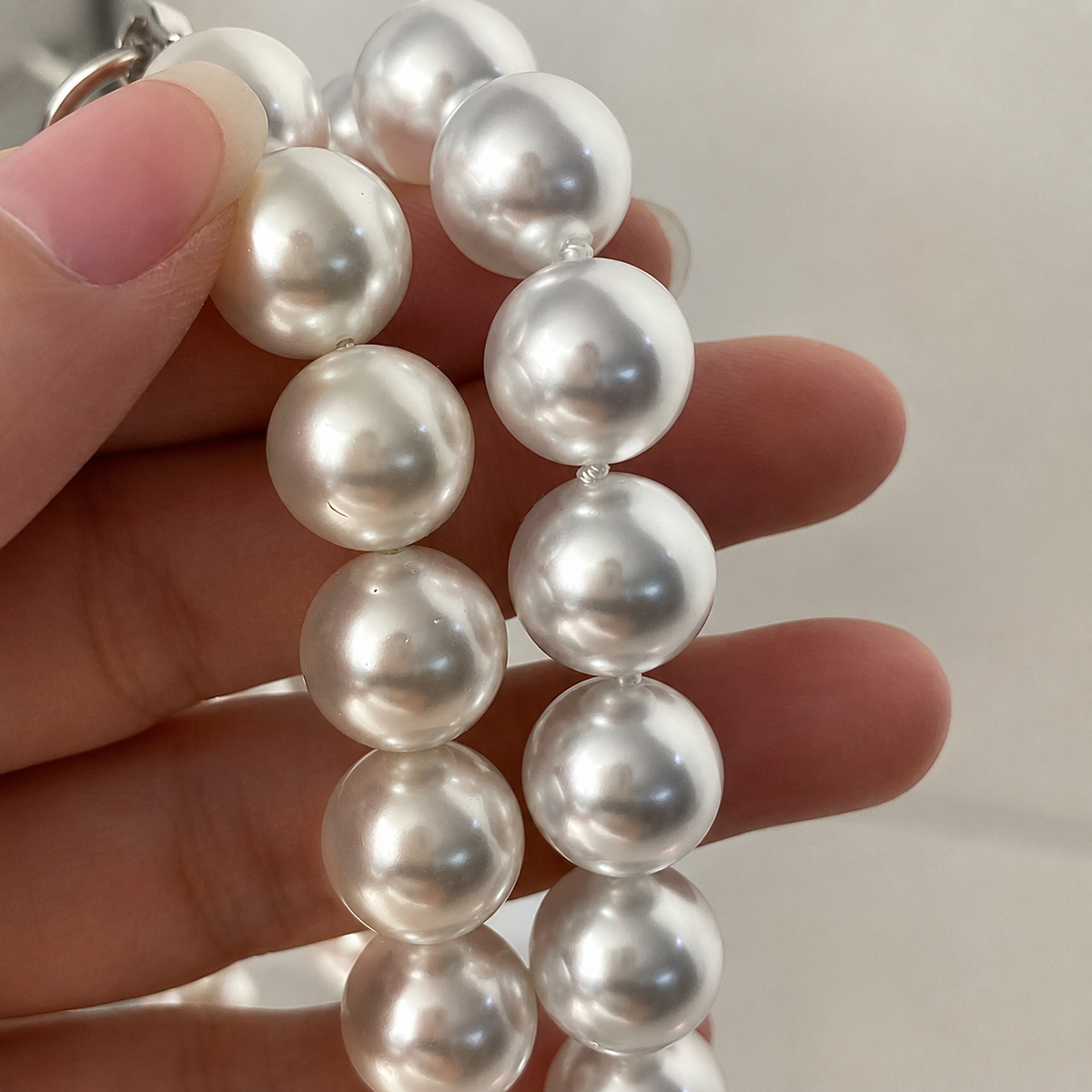 Close-up showing the luminous lustre of 12mm Aurora Akoya pearls
