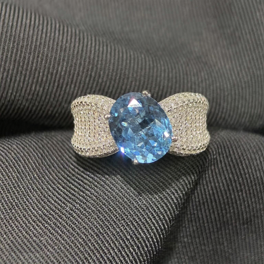 Front view of oval lab-grown aquamarine bow statement ring for fashion events