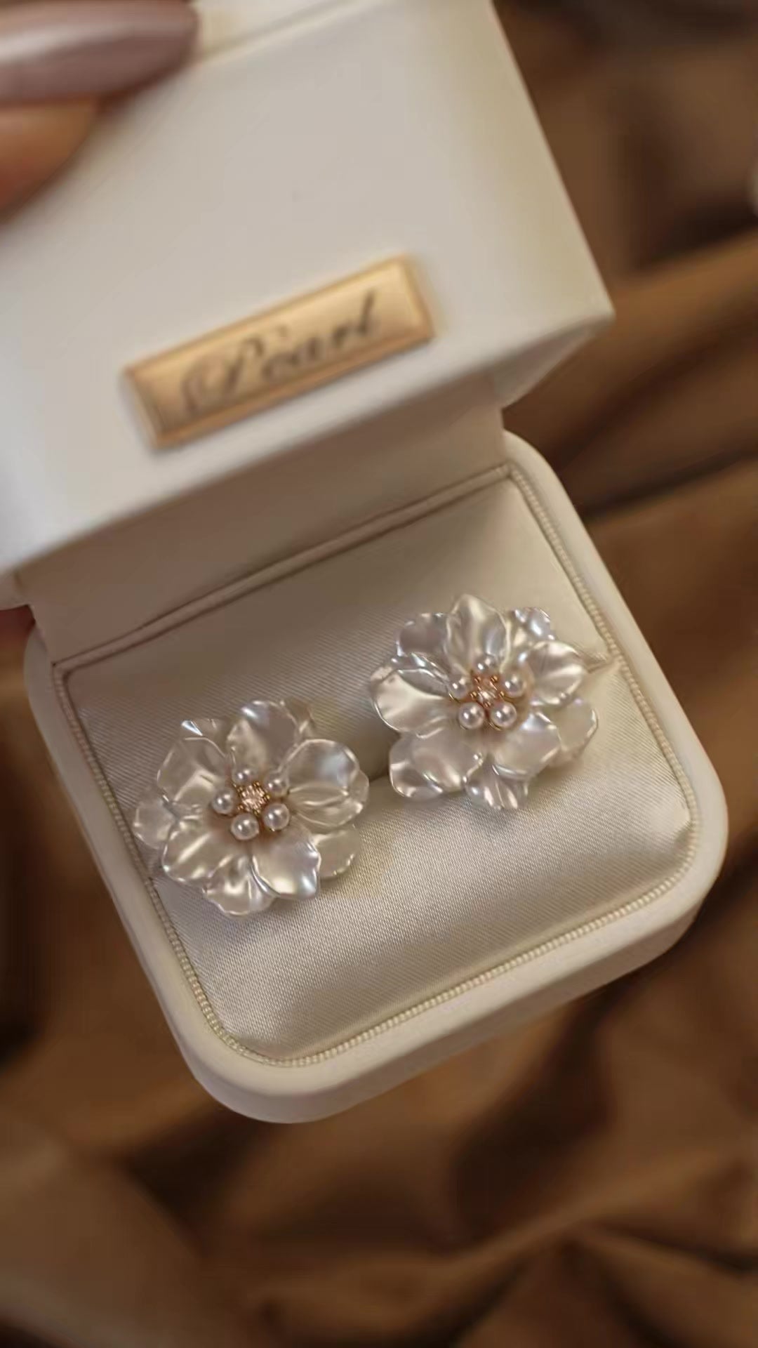 Front view of white flower high-lustre freshwater pearl earrings for wedding guest looks