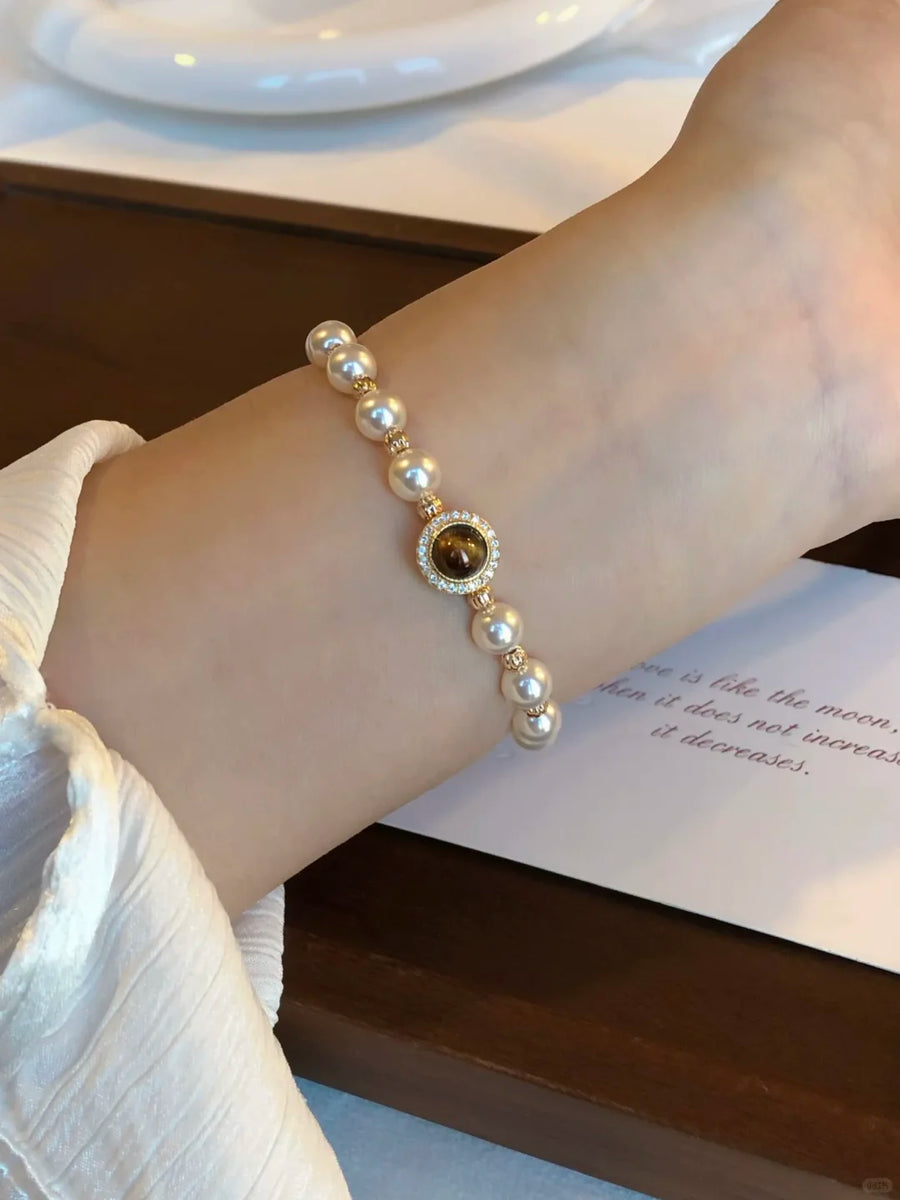 Styled view of dark medallion high-lustre freshwater pearl bracelet for bridal styling