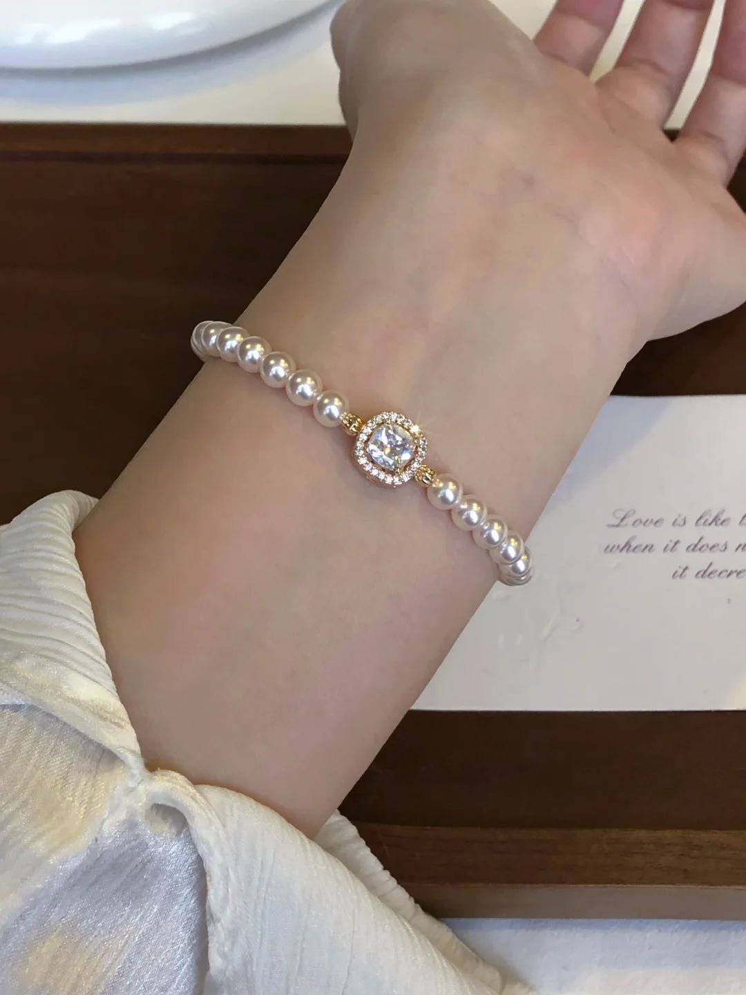 Front view of oval cameo high-lustre freshwater pearl bracelet for bridal styling