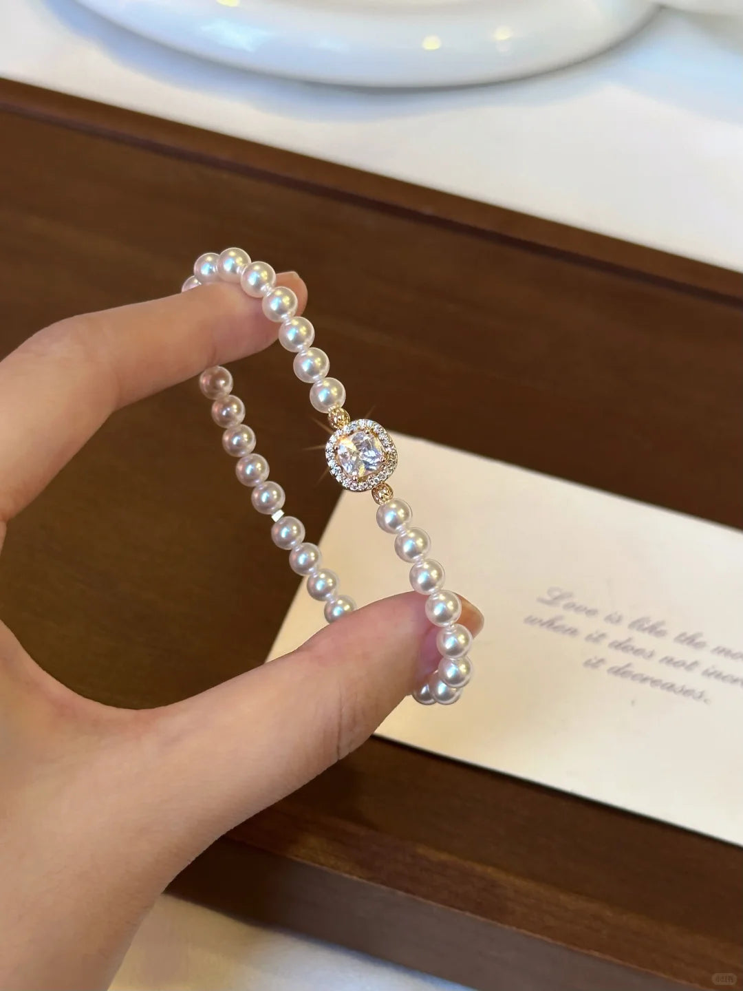 Detail view of oval cameo high-lustre freshwater pearl bracelet for bridal styling