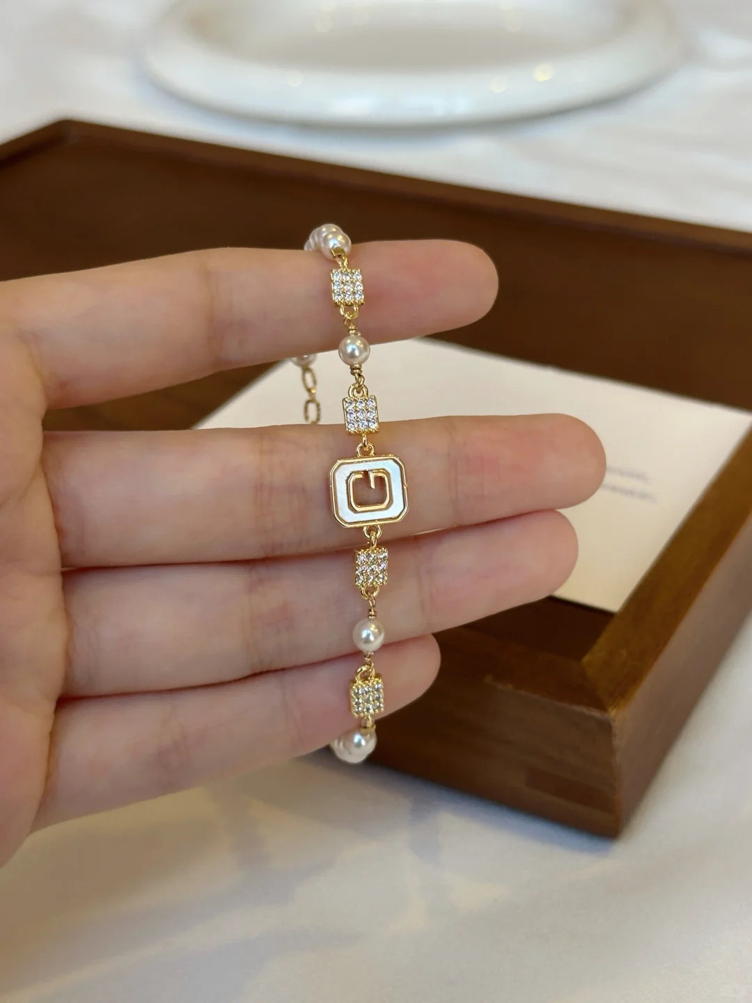 Front view of geometric station high-lustre freshwater pearl bracelet for bridal styling