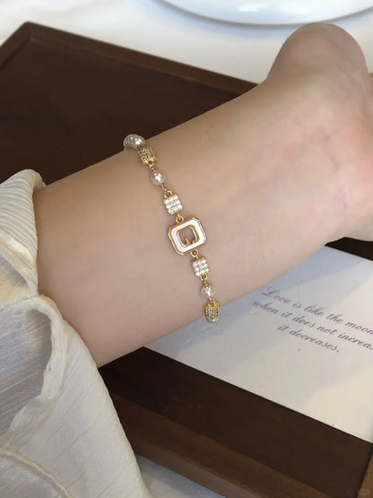 Styled view of geometric station high-lustre freshwater pearl bracelet for bridal styling