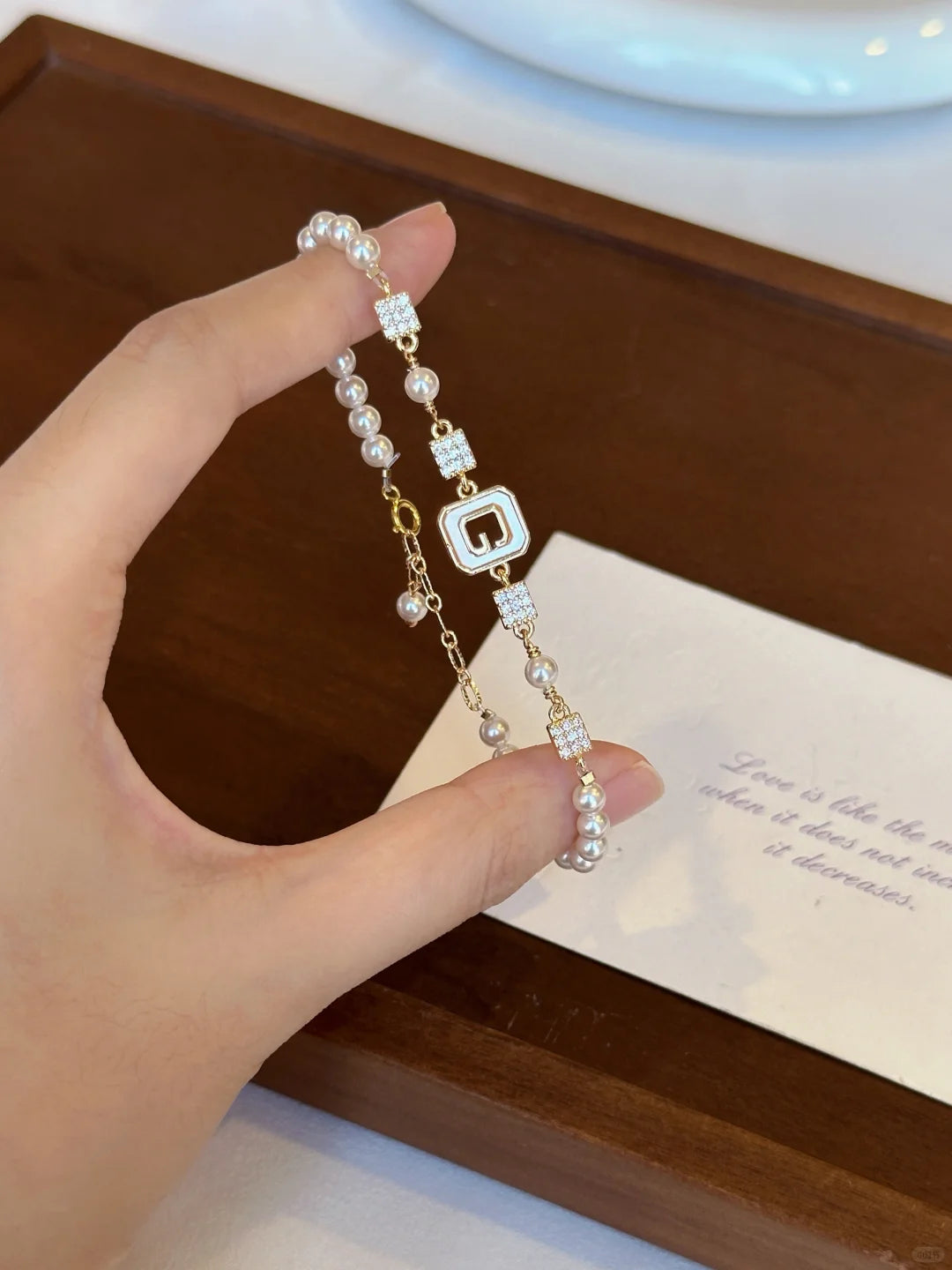 Detail view of geometric station high-lustre freshwater pearl bracelet for bridal styling