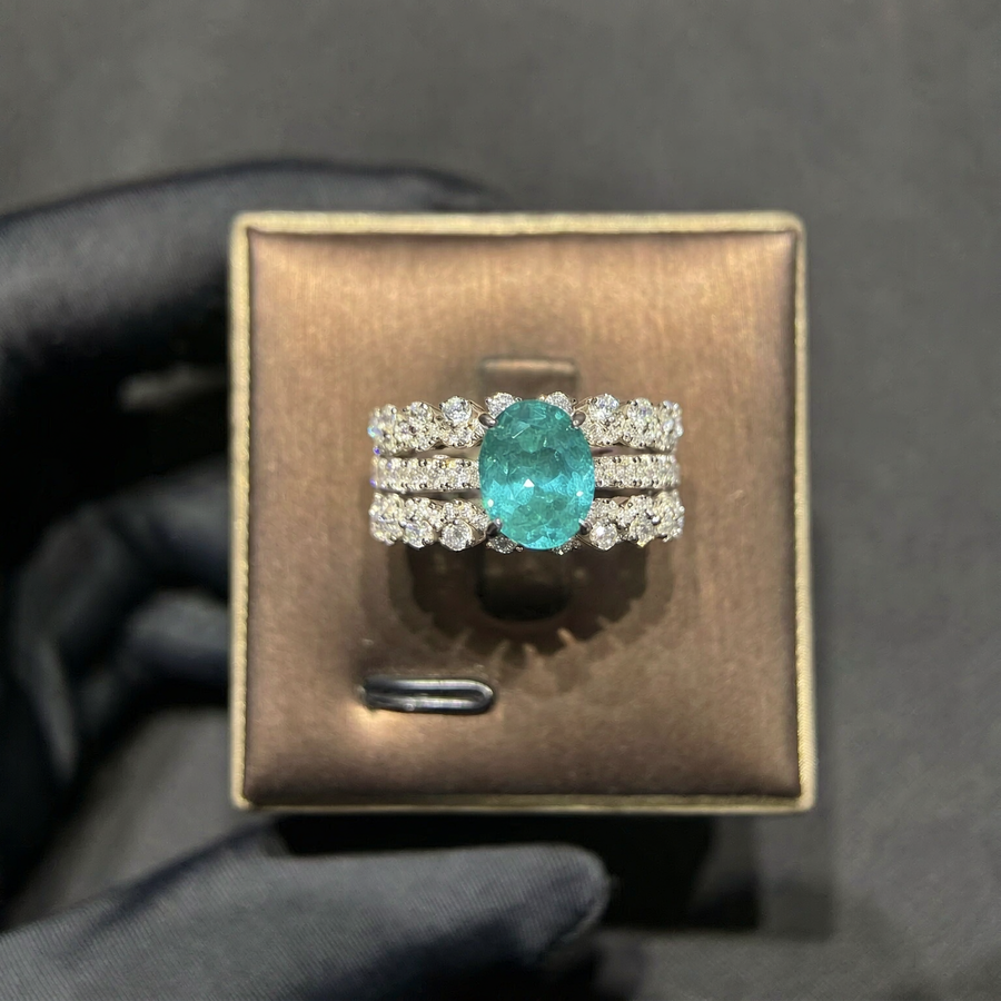 Front view of oval lab-grown Paraiba gemstone three-row ring for modern proposals
