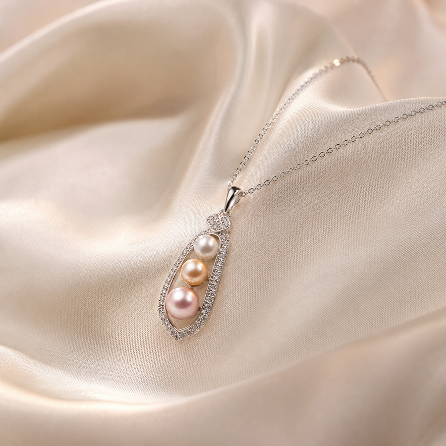 Close-up of three Akoya pearls in a sterling silver teardrop pendant