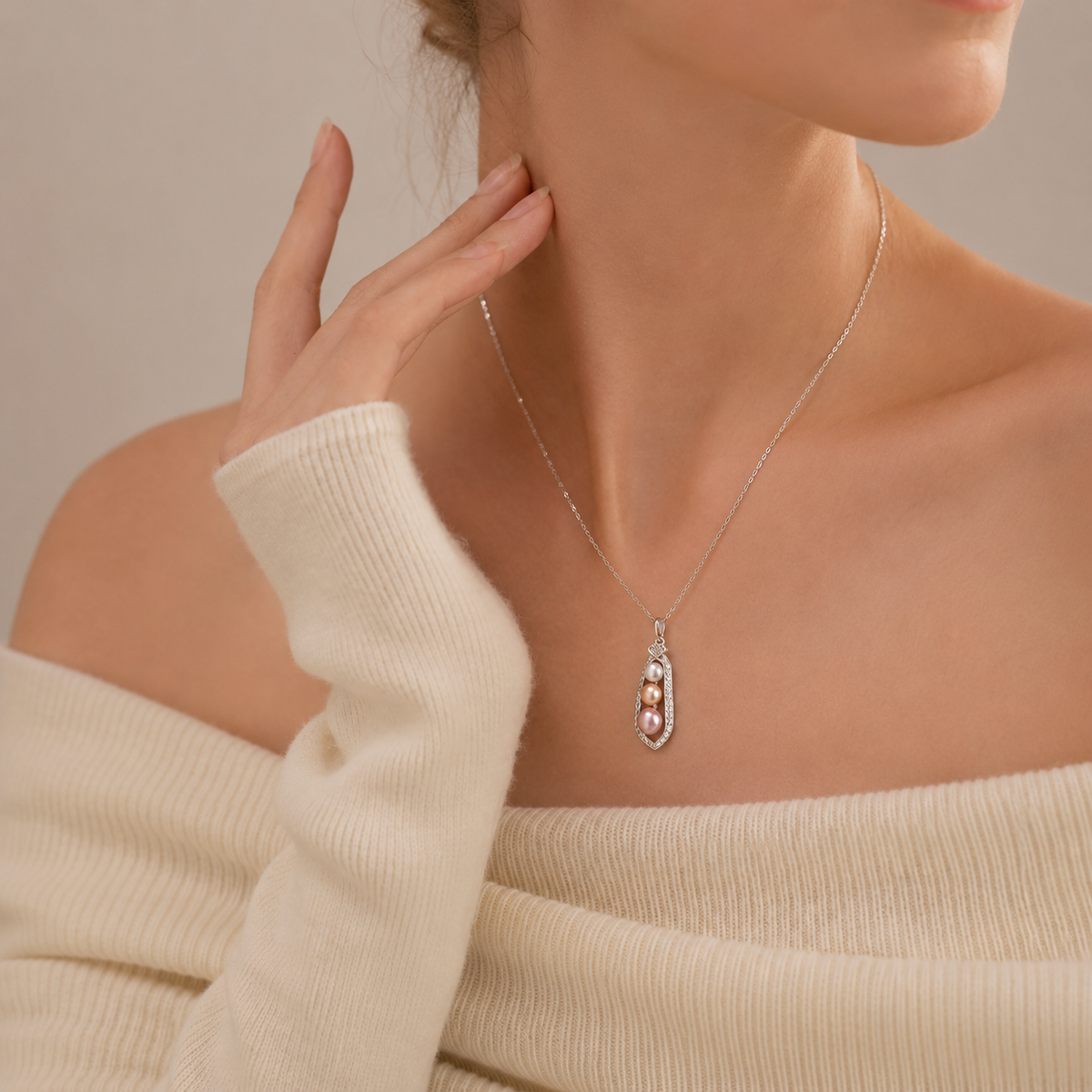Model wearing an Akoya pearl trio pendant necklace with an ivory top