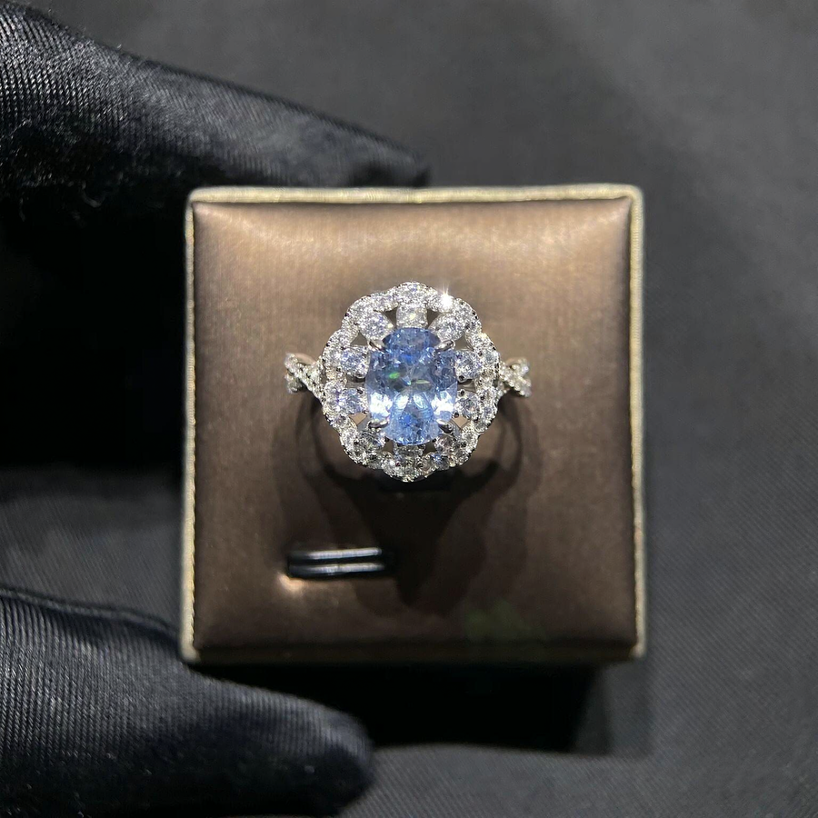 Front view of oval lab-grown aquamarine floral halo ring for engagement celebrations