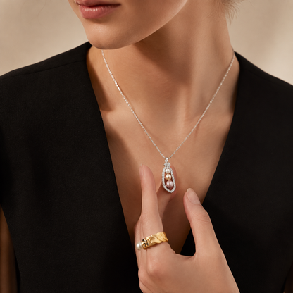 Model wearing the Celeste Akoya pearl pendant necklace with evening tailoring