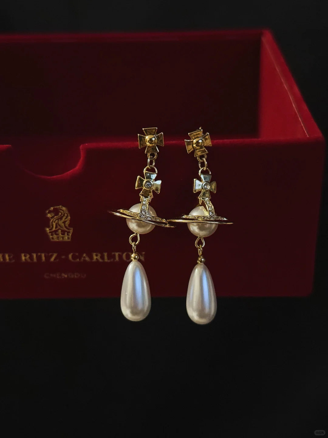 Styled view of orb drop high-lustre freshwater pearl earrings for wedding guest looks