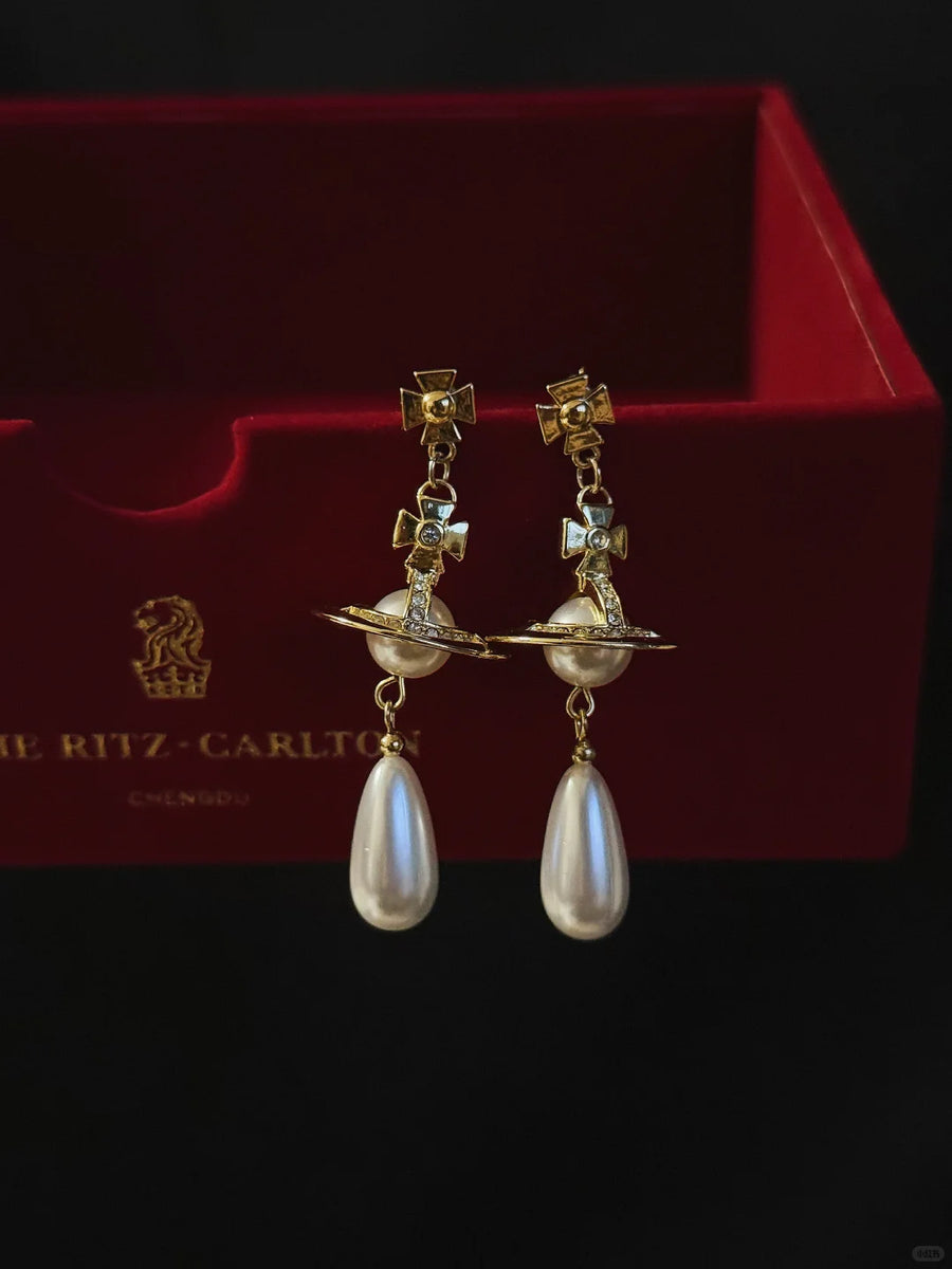 Styled view of orb drop high-lustre freshwater pearl earrings for wedding guest looks