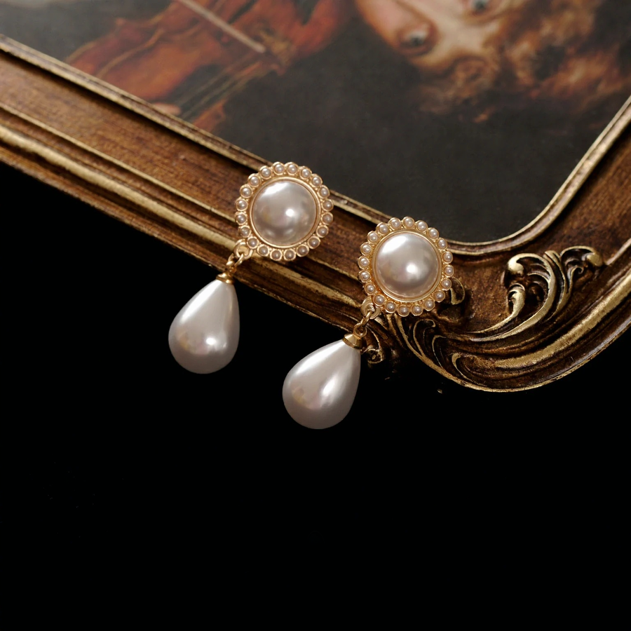 Front view of teardrop halo high-lustre freshwater pearl earrings for wedding guest looks