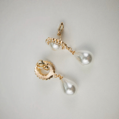 Styled view of teardrop halo high-lustre freshwater pearl earrings for wedding guest looks