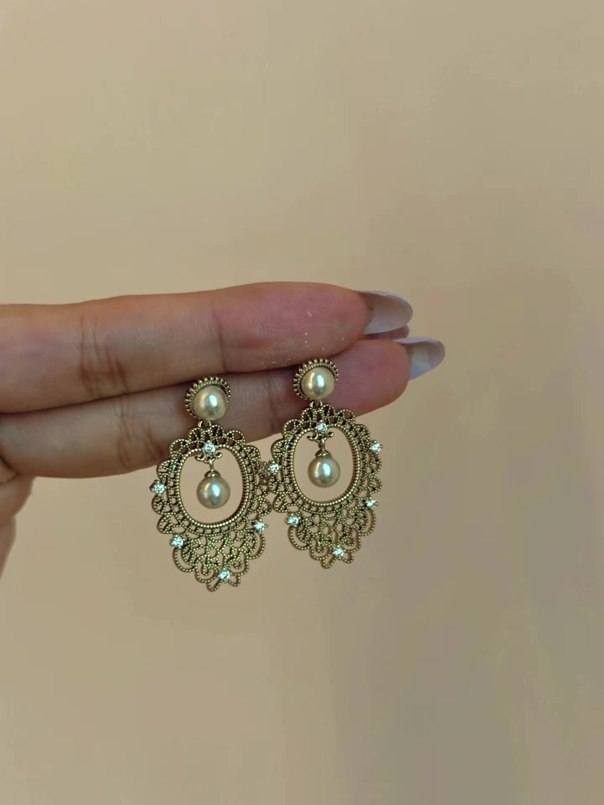 Styled view of vintage lace high-lustre freshwater pearl earrings for wedding guest looks