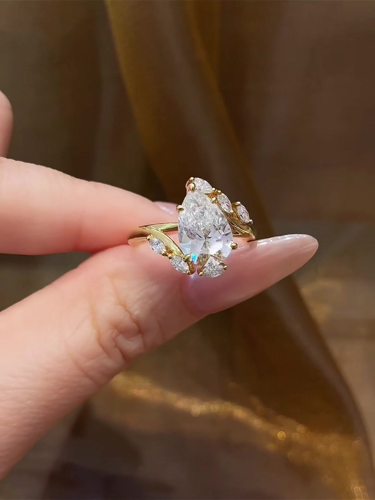 Front view of lab-grown diamond pear wheat engagement ring for romantic proposals