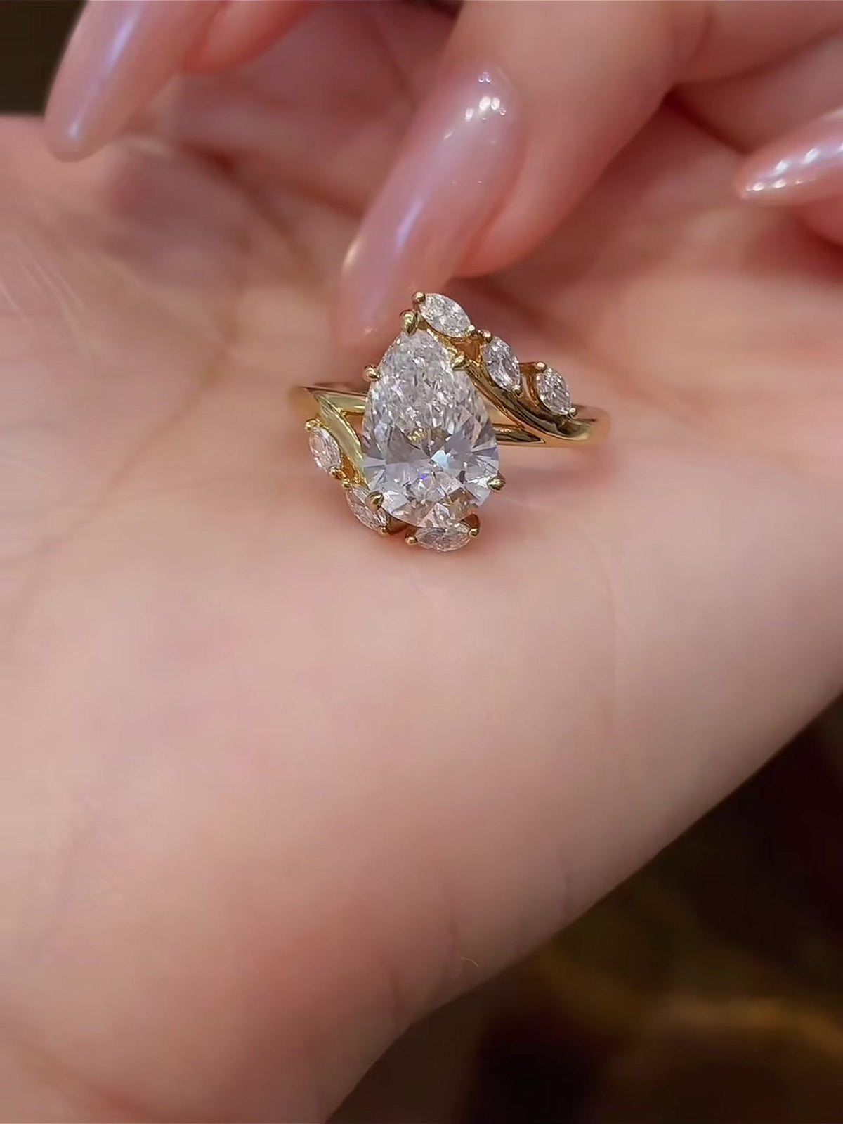 Styled view of lab-grown diamond pear wheat engagement ring for romantic proposals