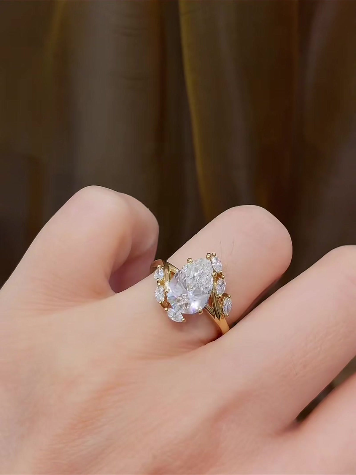 Close-up of lab-grown diamond pear wheat engagement ring for romantic proposals