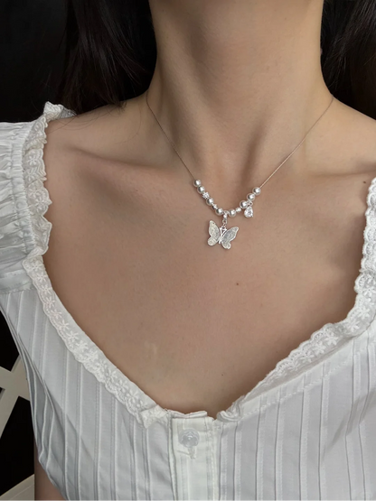 Styled view of butterfly pendant high-lustre freshwater pearl necklace for weddings