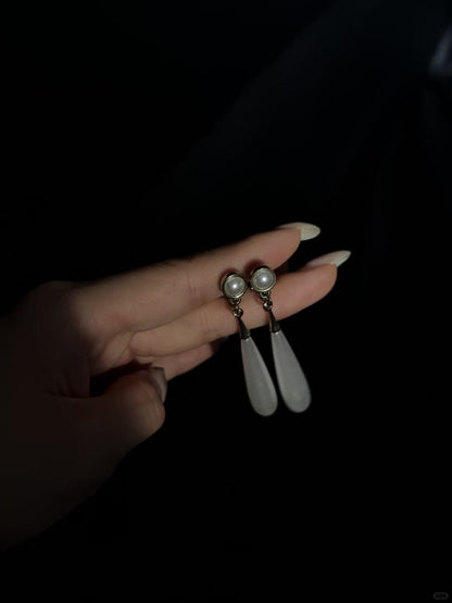 Front view of teardrop high-lustre freshwater pearl earrings for wedding guest looks