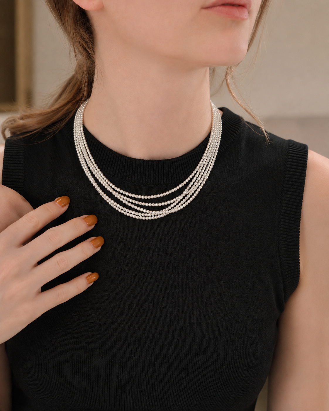 Triple-strand 4mm pearl necklace styled with a black outfit