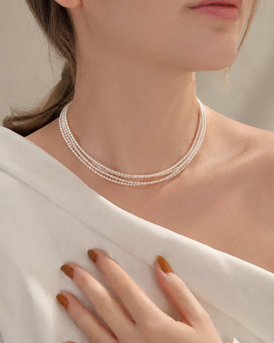 Model wearing a 46cm triple-strand freshwater pearl necklace with an ivory top