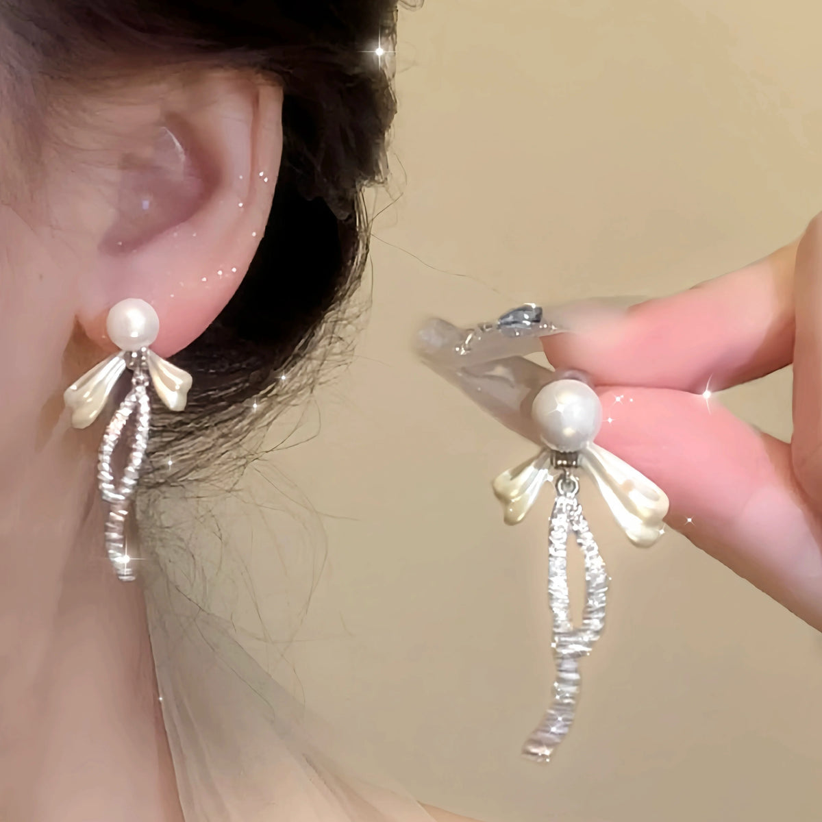Fleurine freshwater pearl bow drop earrings worn with an elegant evening outfit