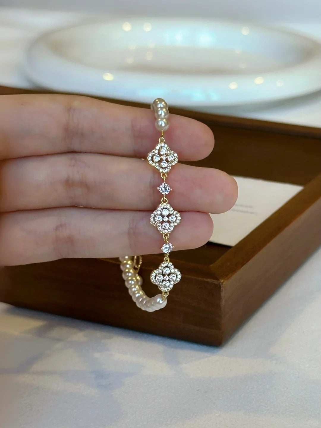 Styled view of flower motif high-lustre freshwater pearl bracelet for bridal styling