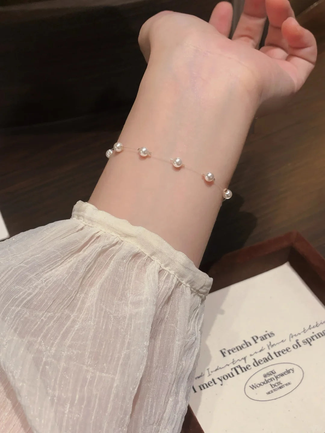 Front view of delicate station high-lustre freshwater pearl bracelet for bridal styling