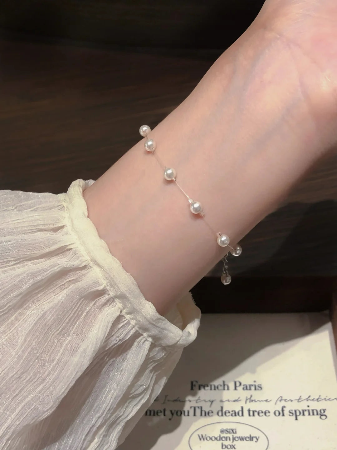 Styled view of delicate station high-lustre freshwater pearl bracelet for bridal styling