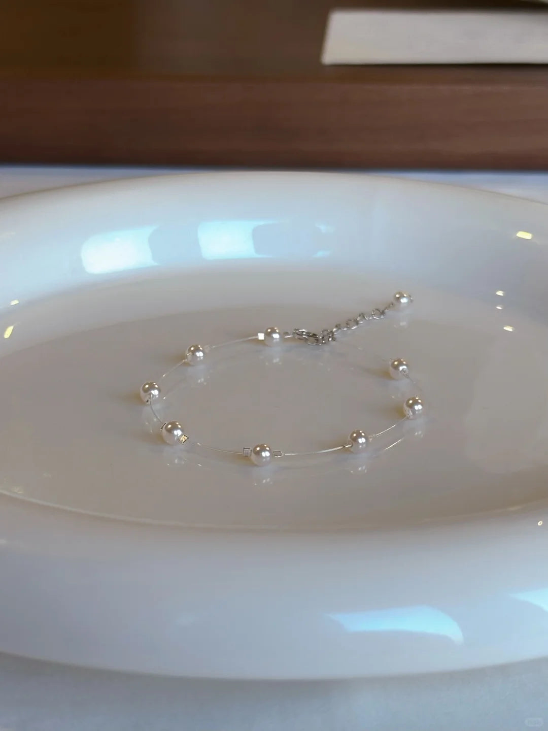 Close-up of delicate station high-lustre freshwater pearl bracelet for bridal styling