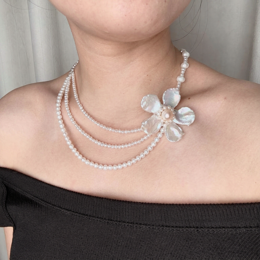 Close-up of Grand Fleur Multi-Strand Pearl Necklace showing natural freshwater baroque pearl details for editorial bridal looks